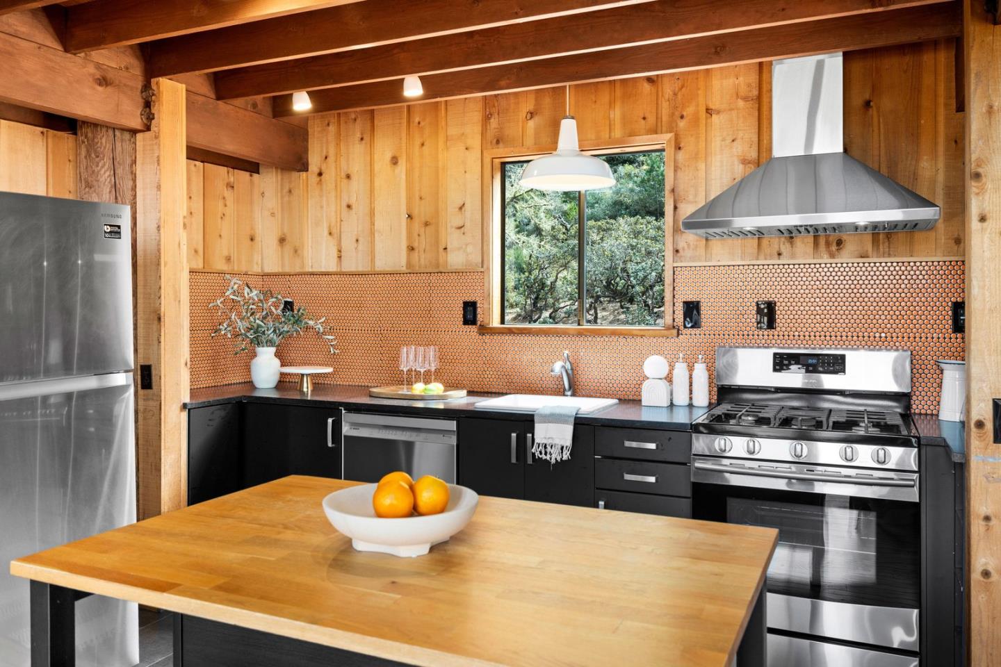 73 Mt Devon Road Carmel Highlands, CA 93923 - Photo 22 of 88 a kitchen with stainless steel appliances a stove a refrigerator and a table