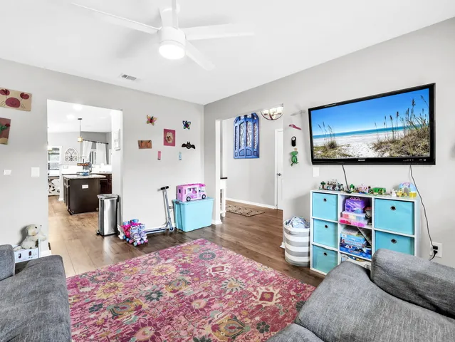 a view of living room with furniture and wooden floor