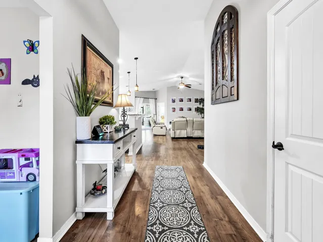 a kitchen with stainless steel appliances kitchen island granite countertop a stove top oven a sink a counter top space and cabinets