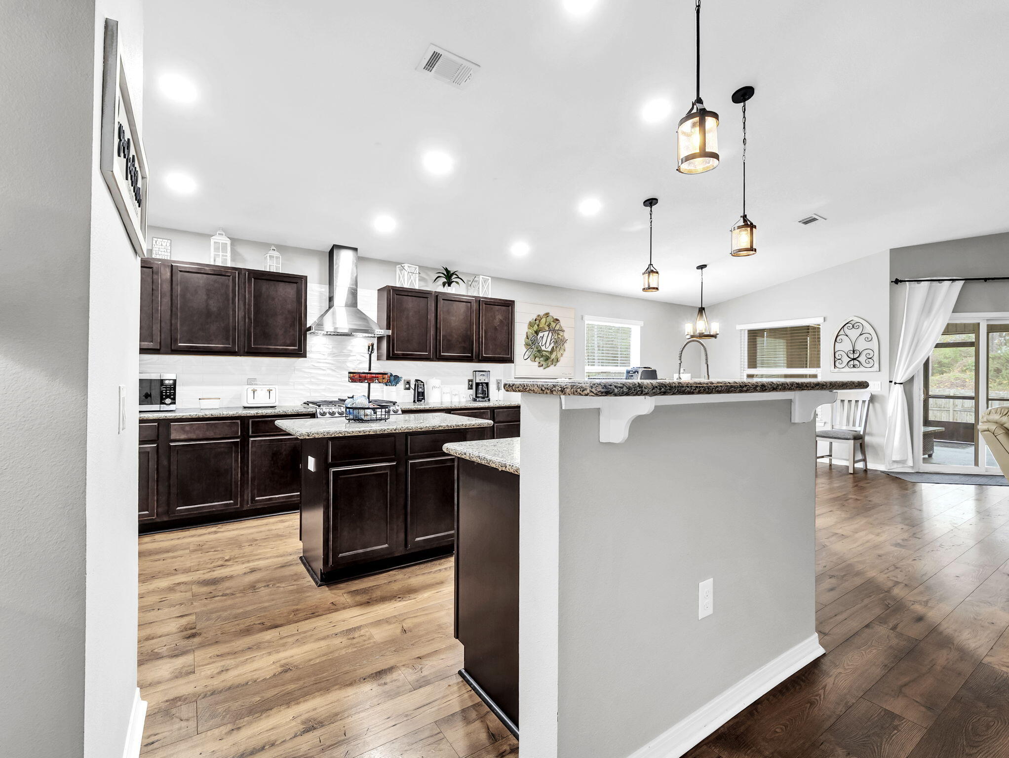 9119 Timber Lane Navarre, FL 32566 - Photo 13 of 53 a kitchen with stainless steel appliances kitchen island granite countertop a stove top oven a sink a counter top space and cabinets
