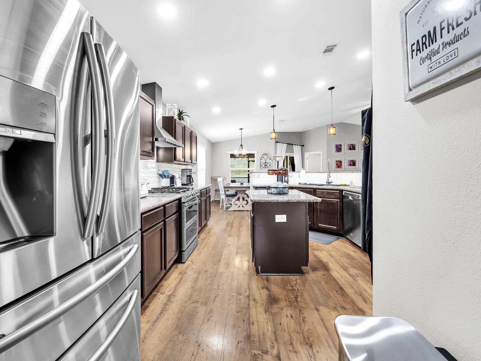 9119 Timber Lane Navarre, FL 32566 - Photo 14 of 53 a kitchen with stainless steel appliances granite countertop a refrigerator a stove top oven and sink