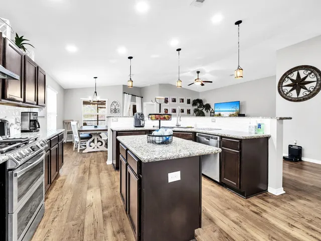 a kitchen with granite countertop stainless steel appliances and sink