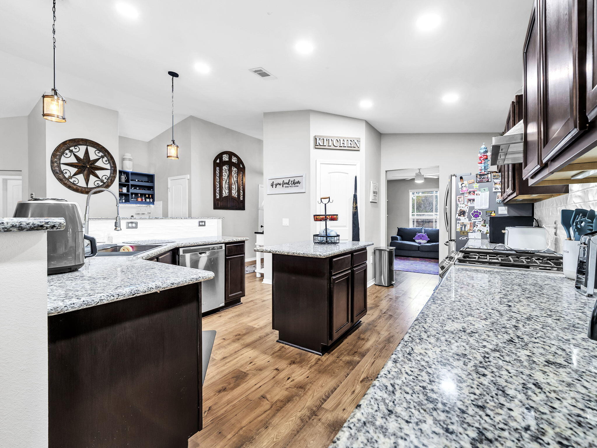 9119 Timber Lane Navarre, FL 32566 - Photo 17 of 53 a large kitchen with stainless steel appliances kitchen island granite countertop a large stove top oven and cabinets