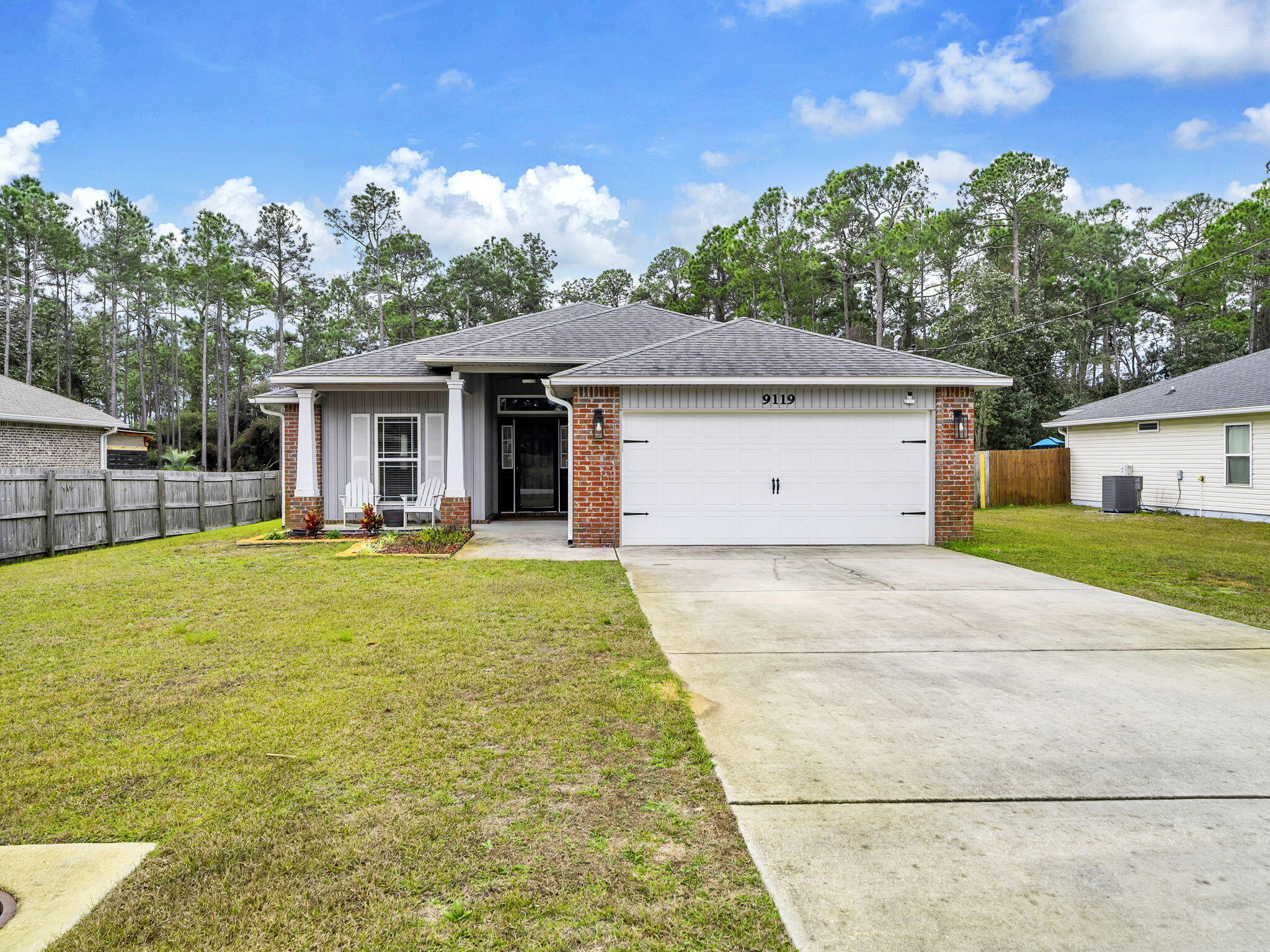 9119 Timber Lane Navarre, FL 32566 - Photo 2 of 53 a view of a house with pool and chairs