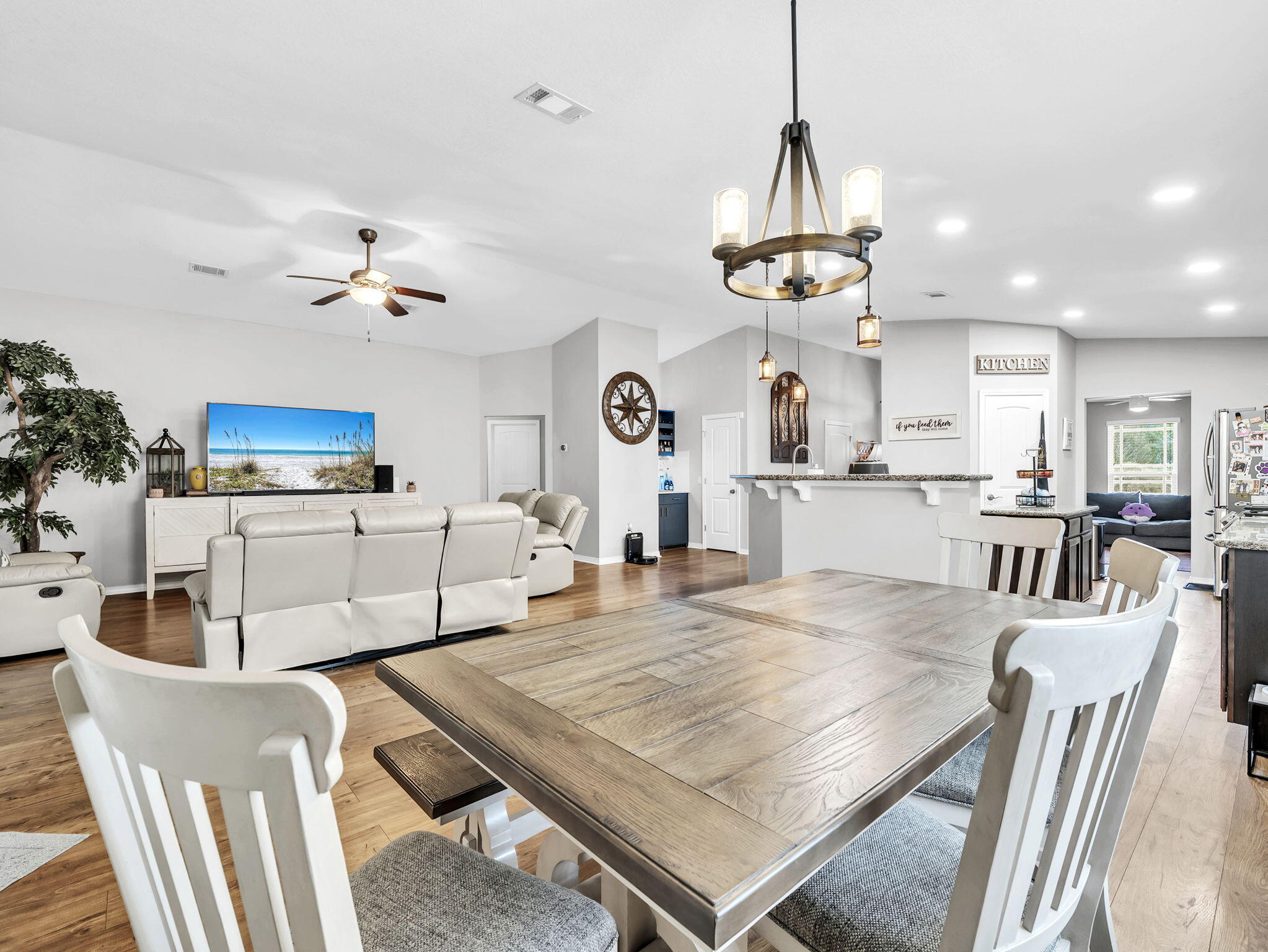 9119 Timber Lane Navarre, FL 32566 - Photo 23 of 53 a living room with dining table and a chandelier