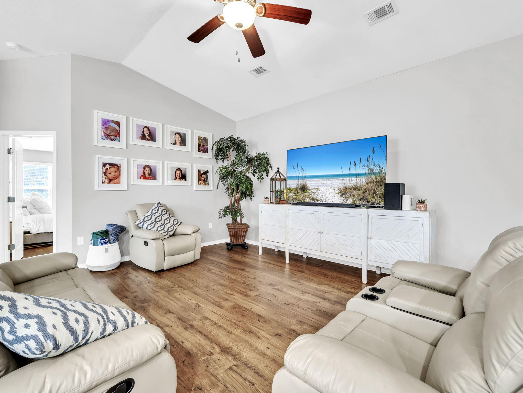 9119 Timber Lane Navarre, FL 32566 - Photo 27 of 53 a living room with furniture and a flat screen tv