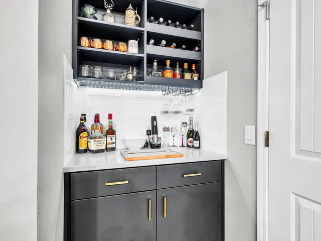 a bedroom with a large bed a chandelier and dresser