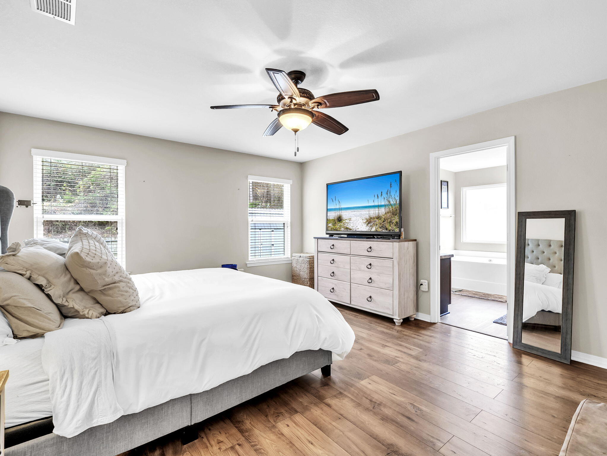 9119 Timber Lane Navarre, FL 32566 - Photo 30 of 53 a bedroom with a large bed a chandelier and dresser