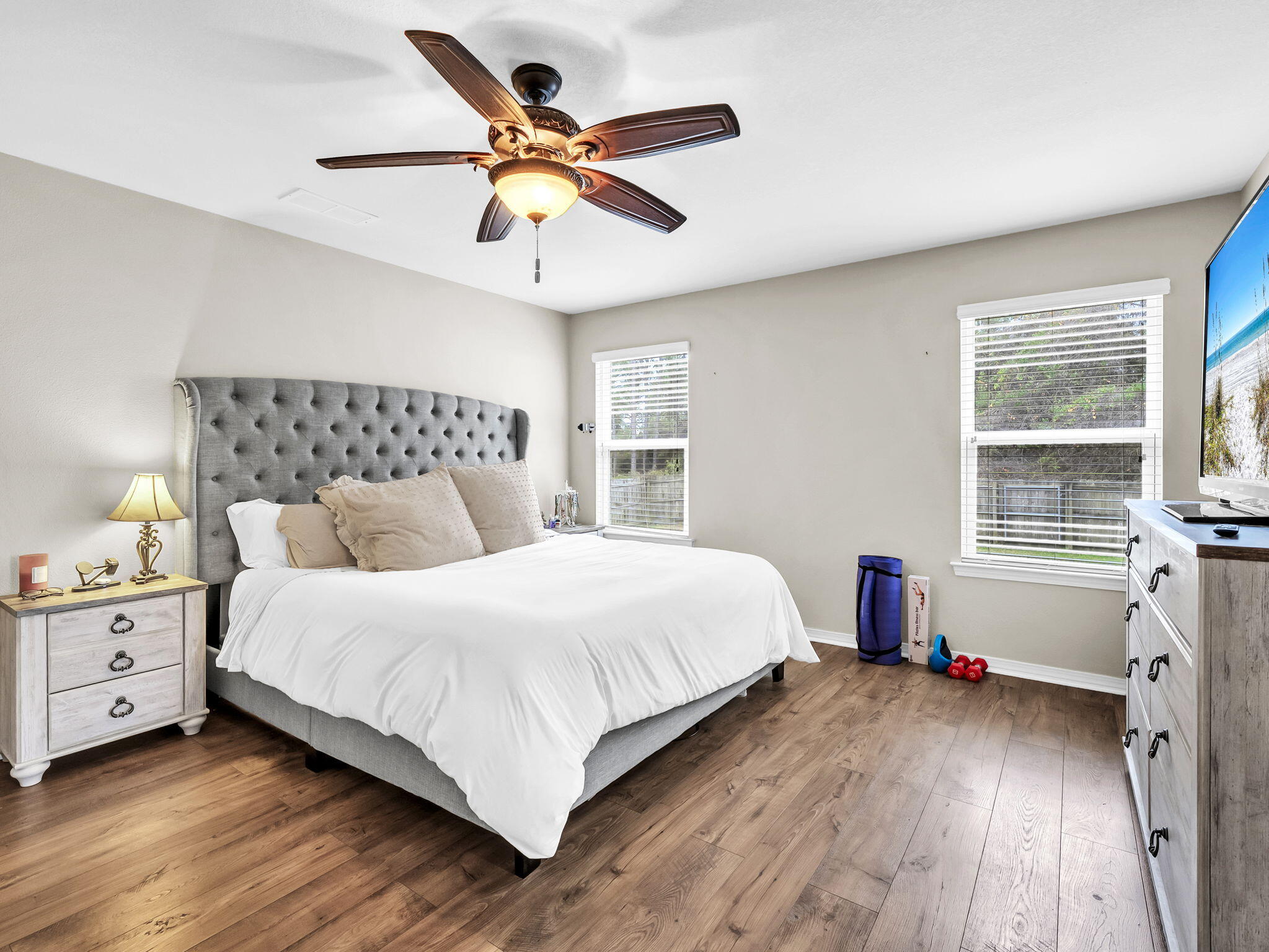 9119 Timber Lane Navarre, FL 32566 - Photo 31 of 53 a bedroom with a large bed and a ceiling fan