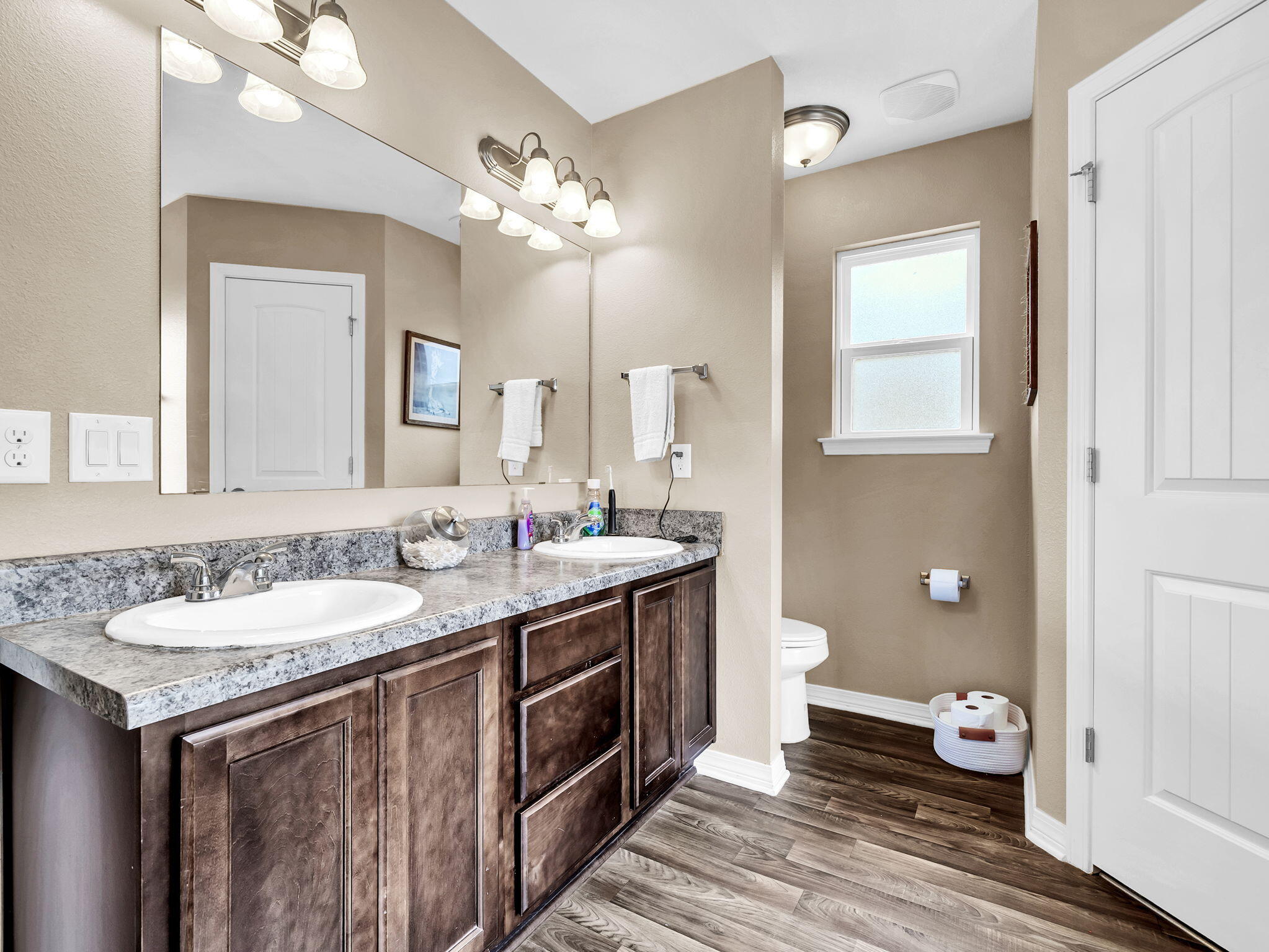 9119 Timber Lane Navarre, FL 32566 - Photo 32 of 53 a bathroom with a granite countertop double vanity sink a mirror and a toilet