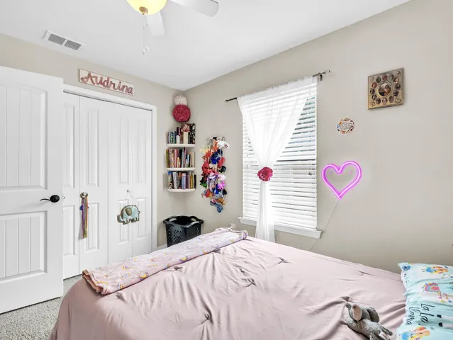 a bedroom with bed and a window
