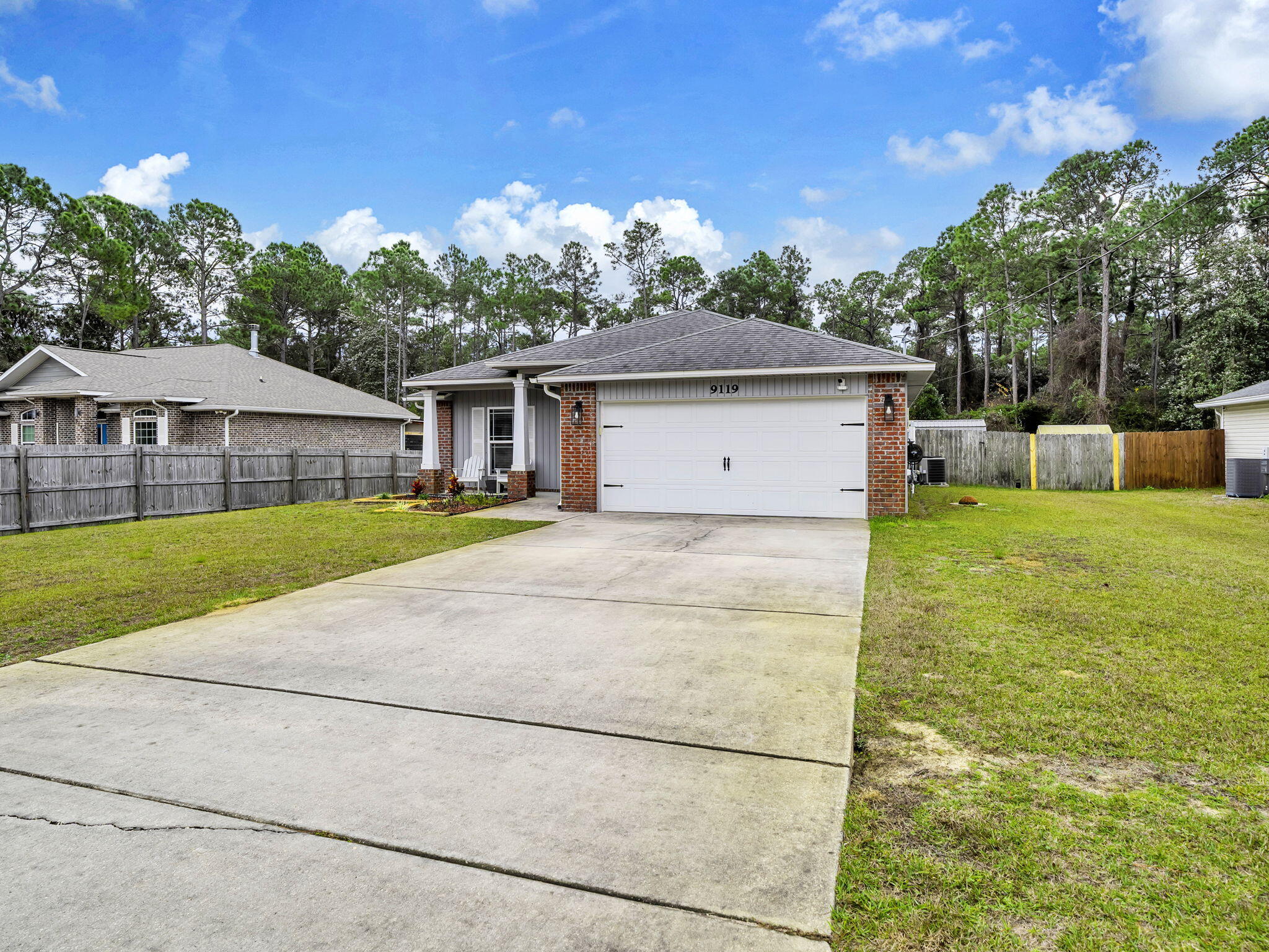 9119 Timber Lane Navarre, FL 32566 - Photo 4 of 53 a house view with a garden space