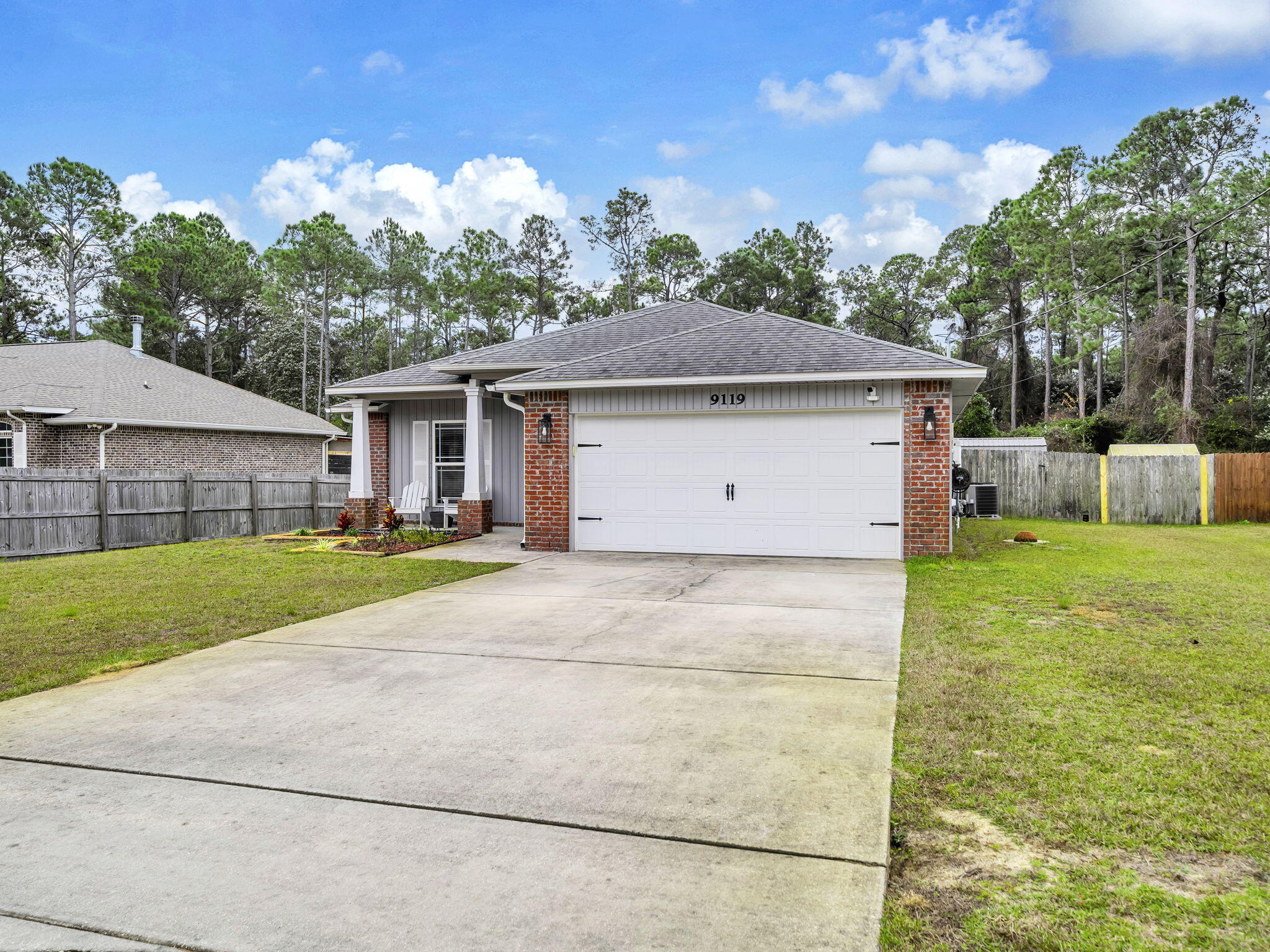 9119 Timber Lane Navarre, FL 32566 - Photo 5 of 53 a house view with a garden space