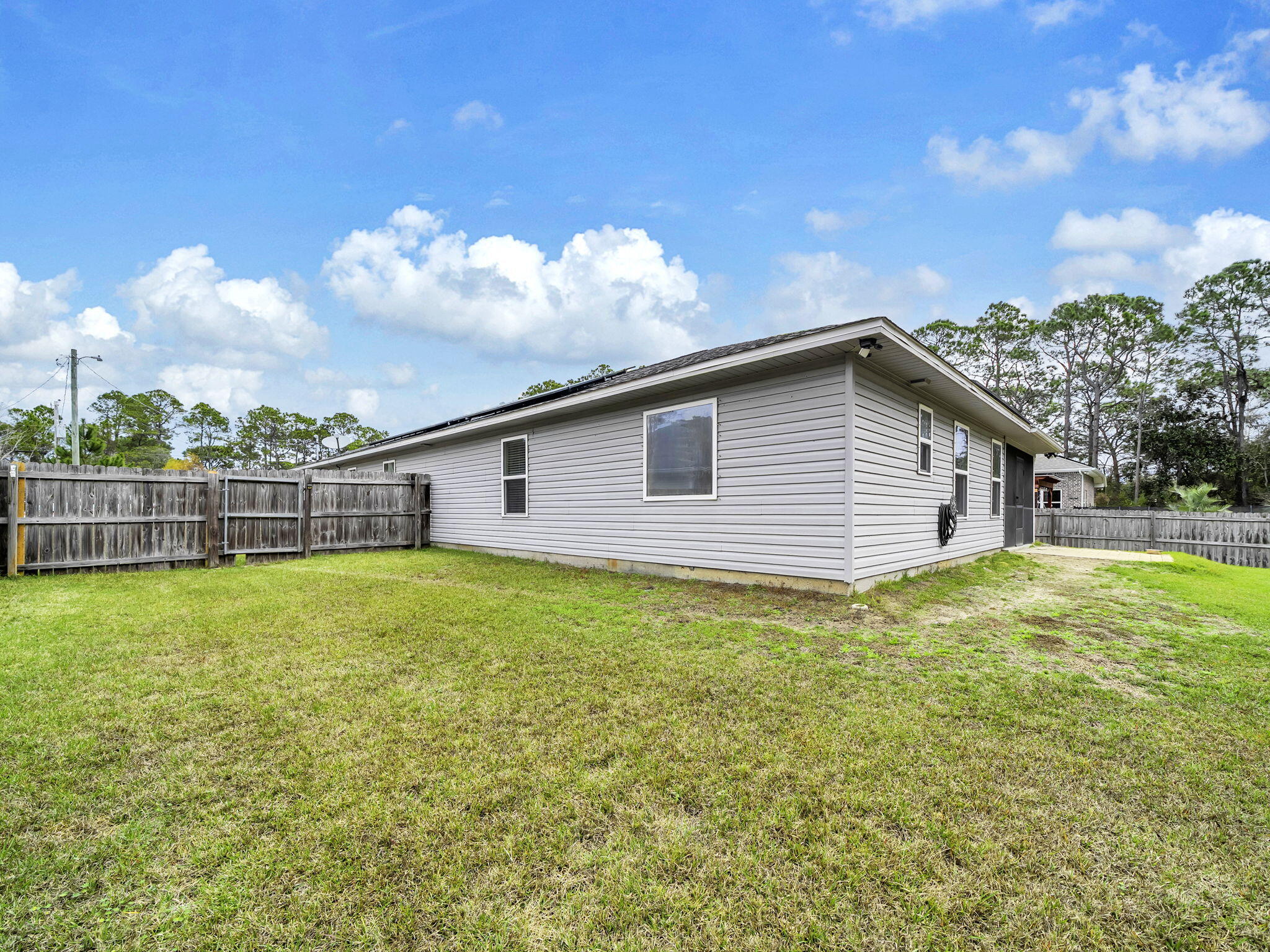 9119 Timber Lane Navarre, FL 32566 - Photo 52 of 53 a backyard of a house with lots of green space