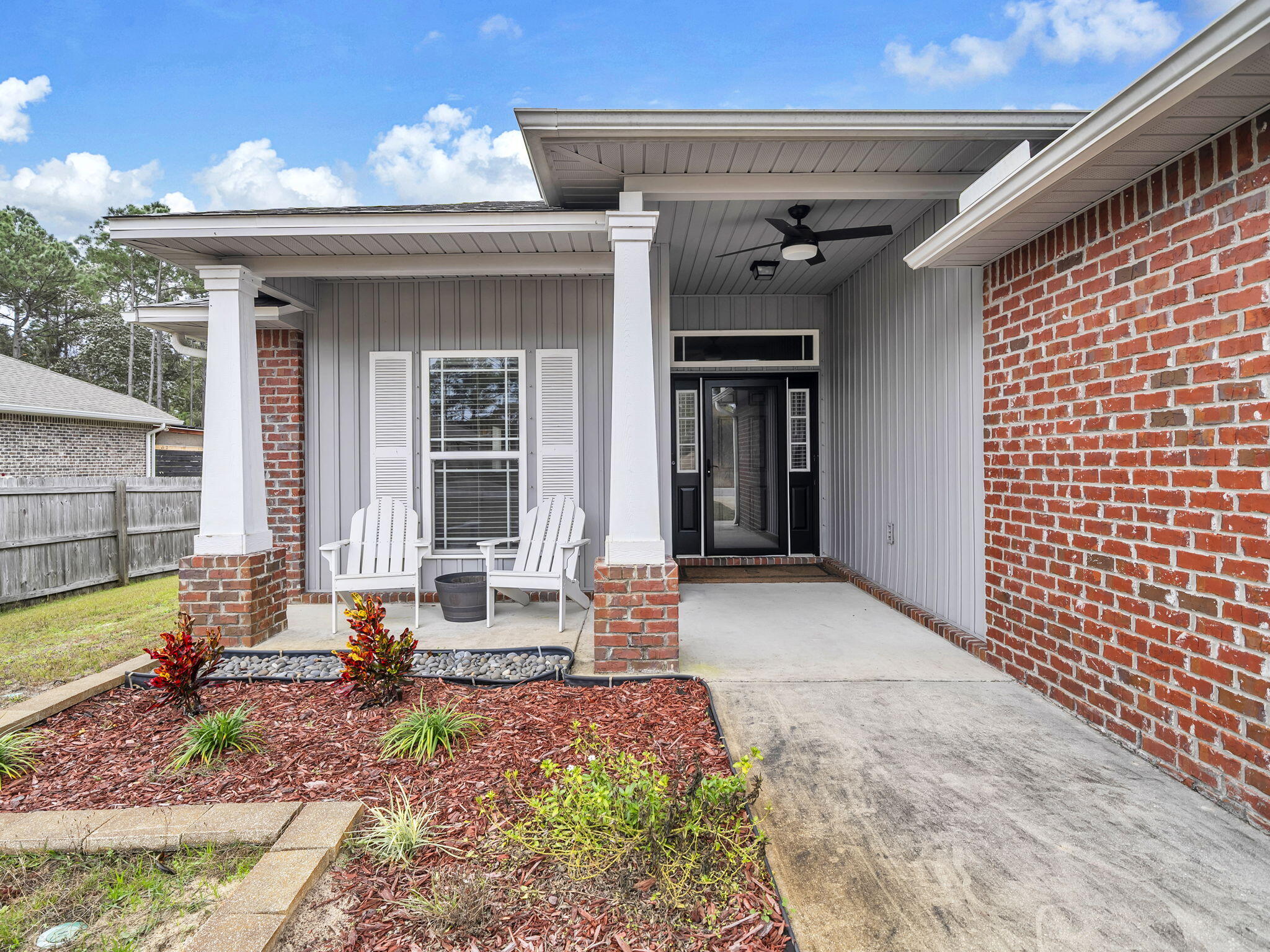 9119 Timber Lane Navarre, FL 32566 - Photo 7 of 53 a front view of a house with outdoor seating