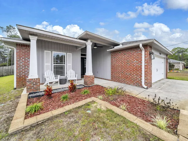 a front view of a house with sitting area