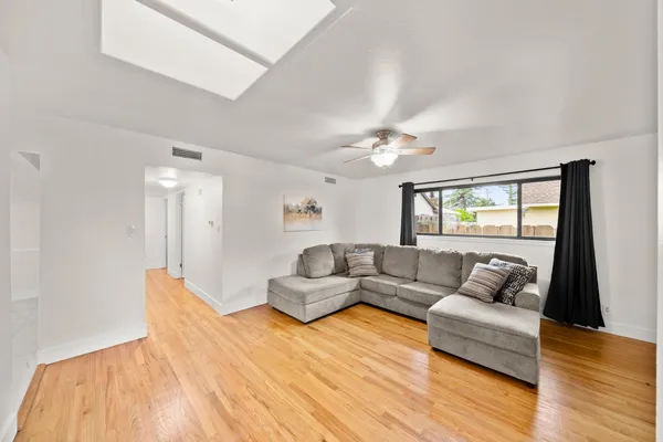 a living room with furniture and a wooden floor