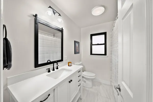 a bathroom with a double vanity sink and a mirror