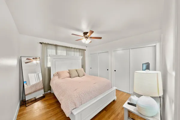 a bedroom with a bed and a chandelier