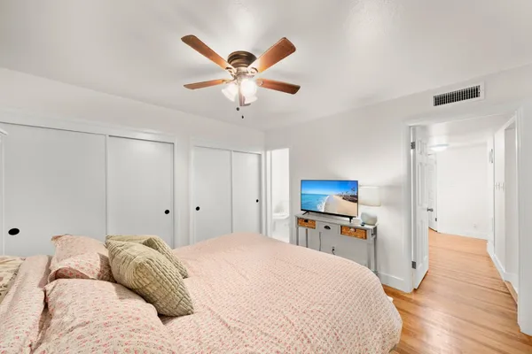 a bedroom with a large bed and a chandelier