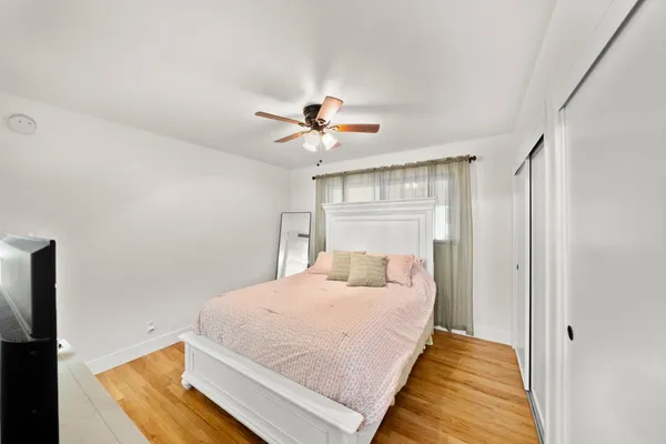 a bedroom with a large bed and a chandelier