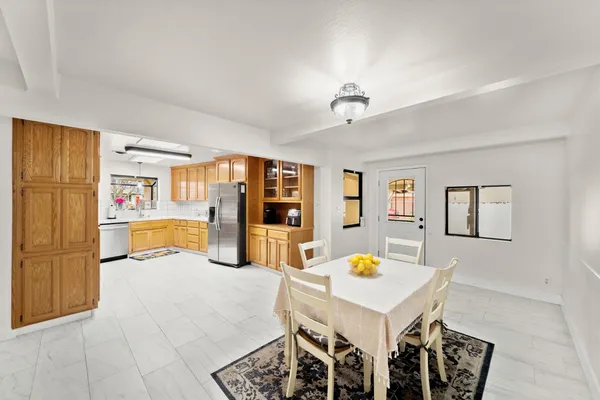 a living room with stainless steel appliances kitchen island granite countertop furniture and a kitchen view