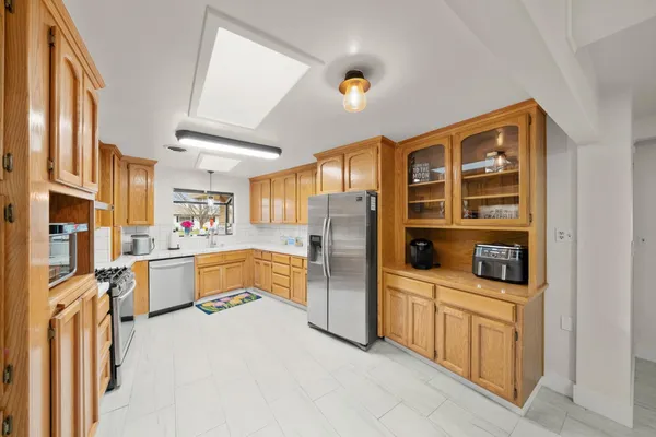 a kitchen with stainless steel appliances a refrigerator and cabinets