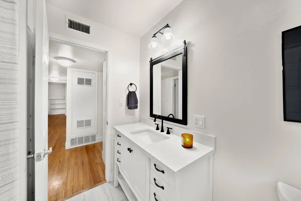 a bathroom with a sink vanity and a mirror