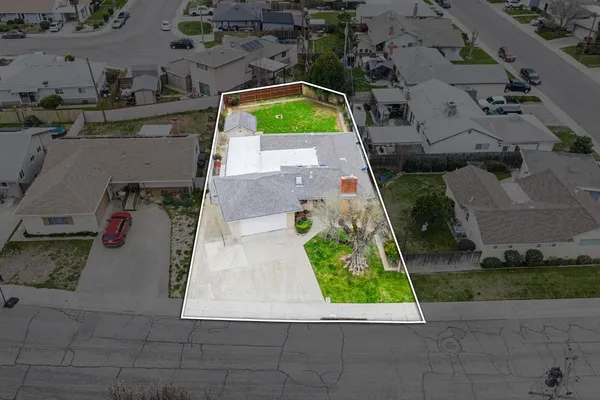 an aerial view of a house with a yard
