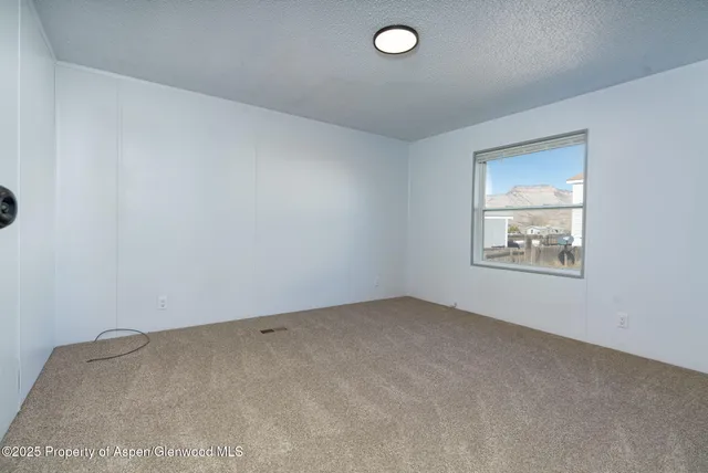 a view of an empty room and a window