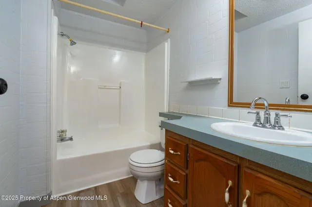 a view of an empty room with window and closet area