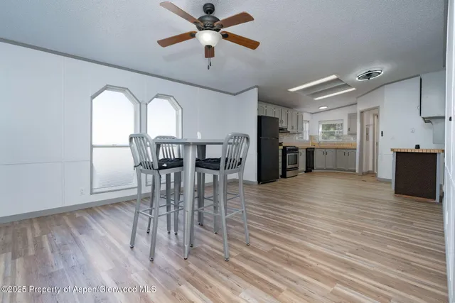 a view of a dining room with furniture and wooden floor