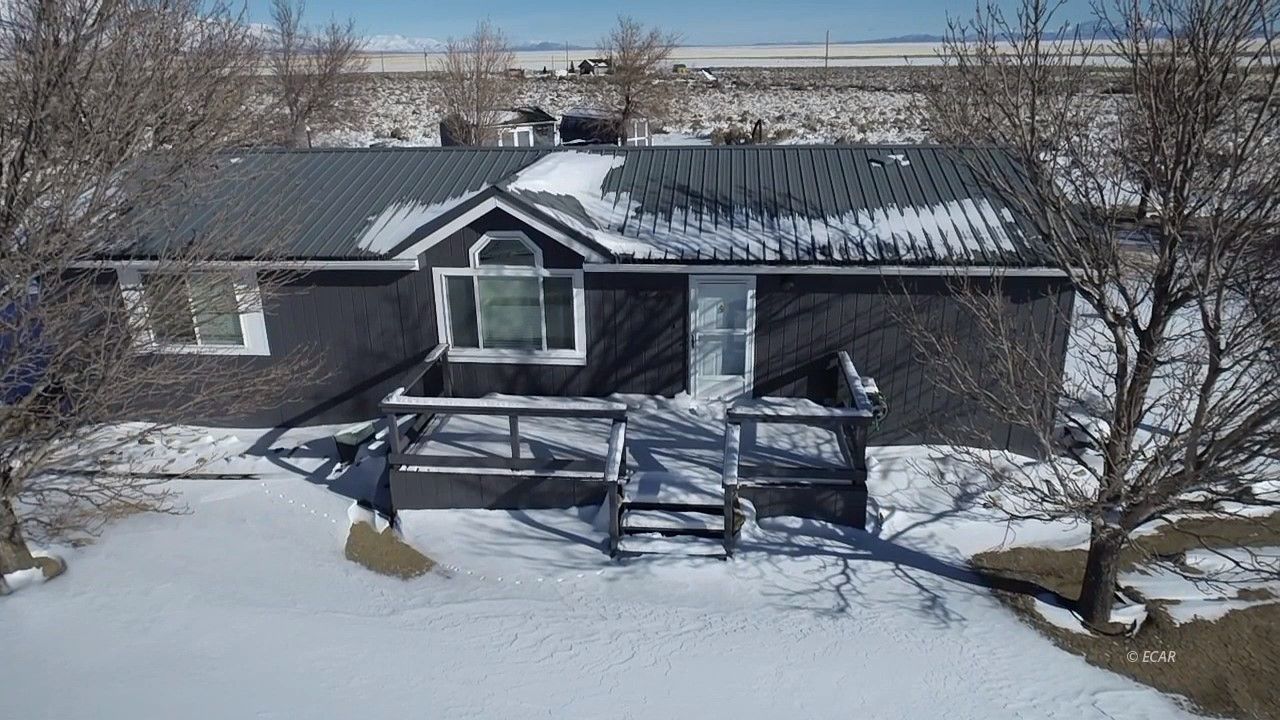 3433 Smith Canyon Road Ruby Valley, NV 89833 - Photo 1 of 37 a view of a roof deck with wooden floor and fence