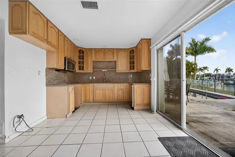 a kitchen with granite countertop a sink and a stove top oven