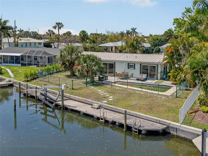 an aerial view of a house with a yard and a fountain