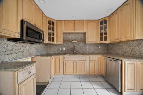a kitchen with stainless steel appliances a refrigerator sink and cabinets