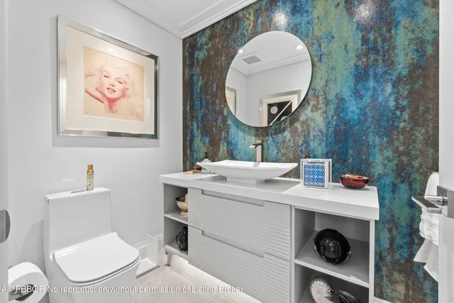 a bathroom with a granite countertop sink and a large mirror