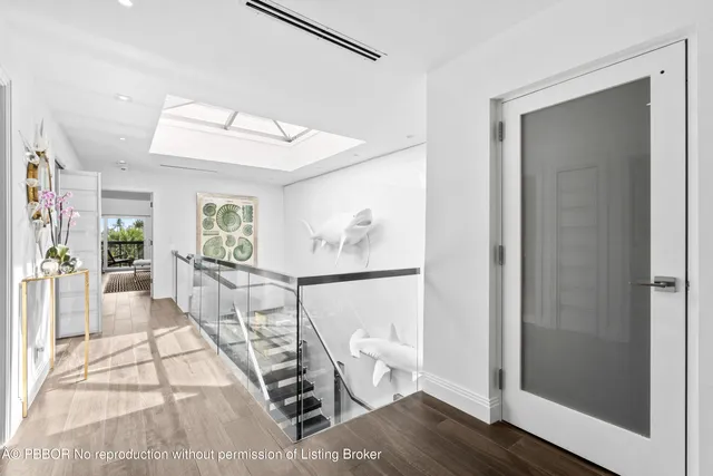 a living room with furniture a mirror and a clock