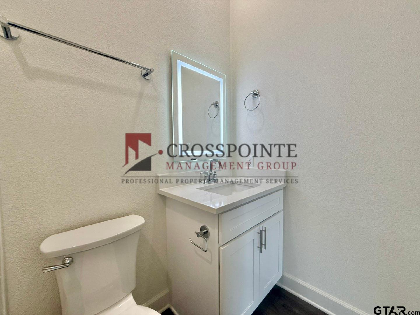 548 West Erwin Street Tyler, TX 75702 - Photo 26 of 27 a bathroom with a sink a toilet and a mirror