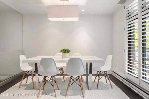 a view of a dining room with furniture and wooden floor