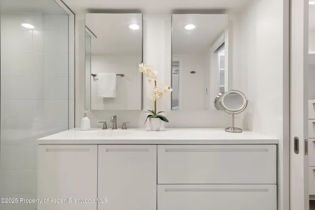 a bathroom with a double vanity sink mirror and
