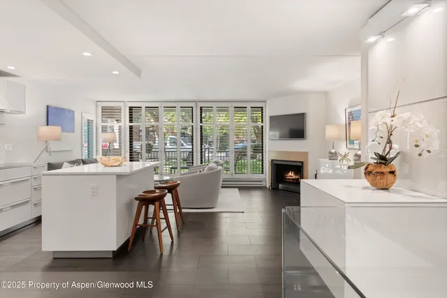 a living room with furniture a fireplace and a table