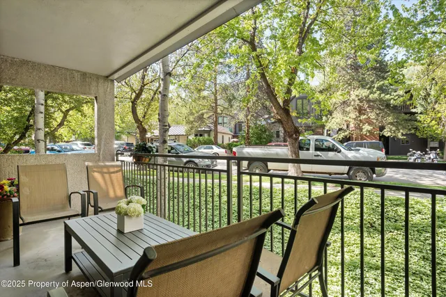 a view of balcony with wooden floor and outdoor seating