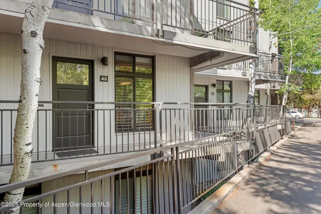 a view of a brick house with large windows