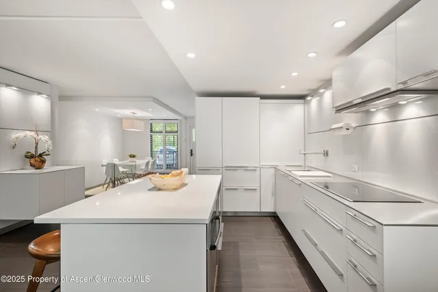a kitchen with a sink a stove and cabinets