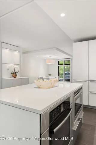 a kitchen with a sink a stove and cabinets