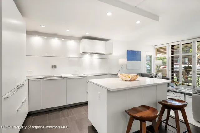 a kitchen with a sink a table and chairs