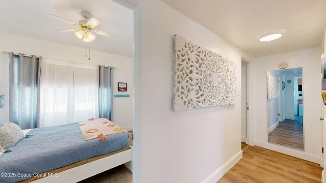 a bathroom with a sink toilet vanity and wooden floor