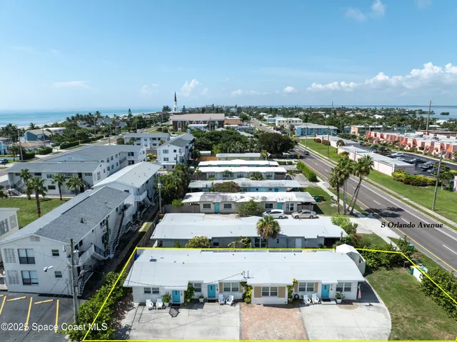 an aerial view of residential houses with outdoor space