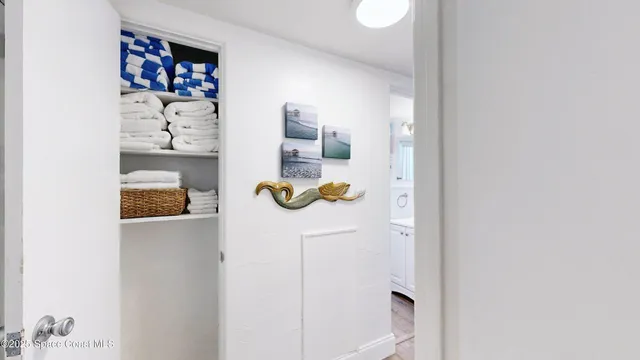 a kitchen with stainless steel appliances granite countertop a refrigerator a sink dishwasher a stove and a dining table with wooden floor